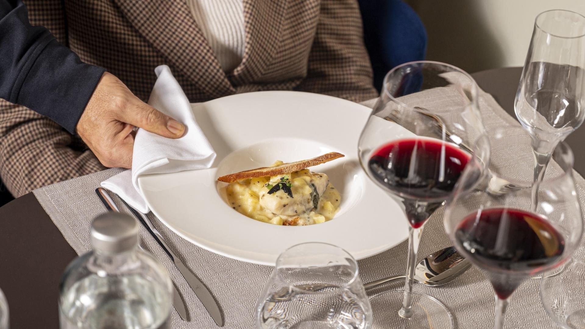 Pasta dish with red wine on an elegant table.