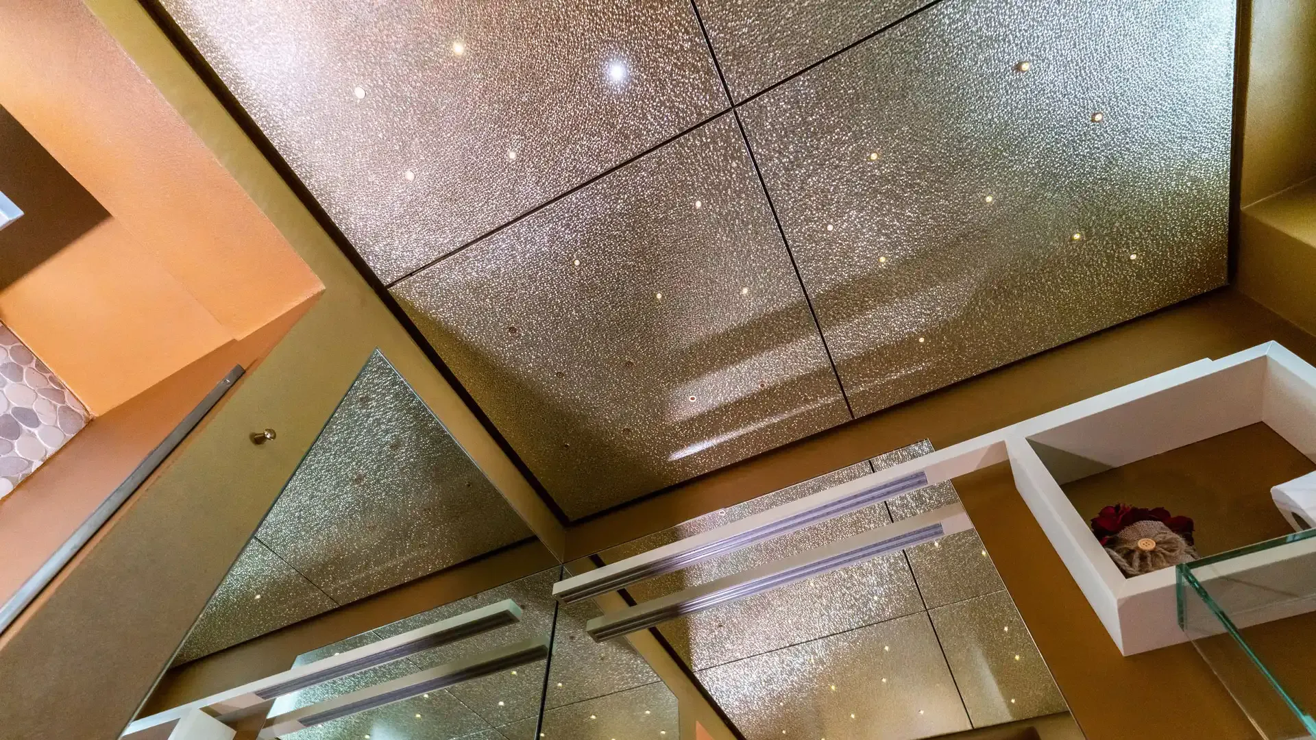 Mirrored ceiling with LED lights in a modern room.