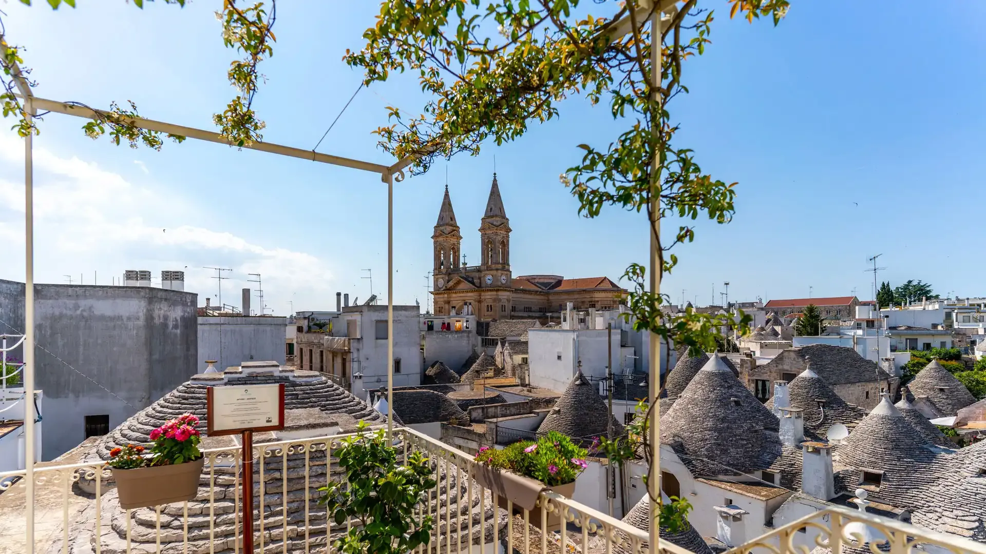 View of the trulli of Alberobello with a church in the background.