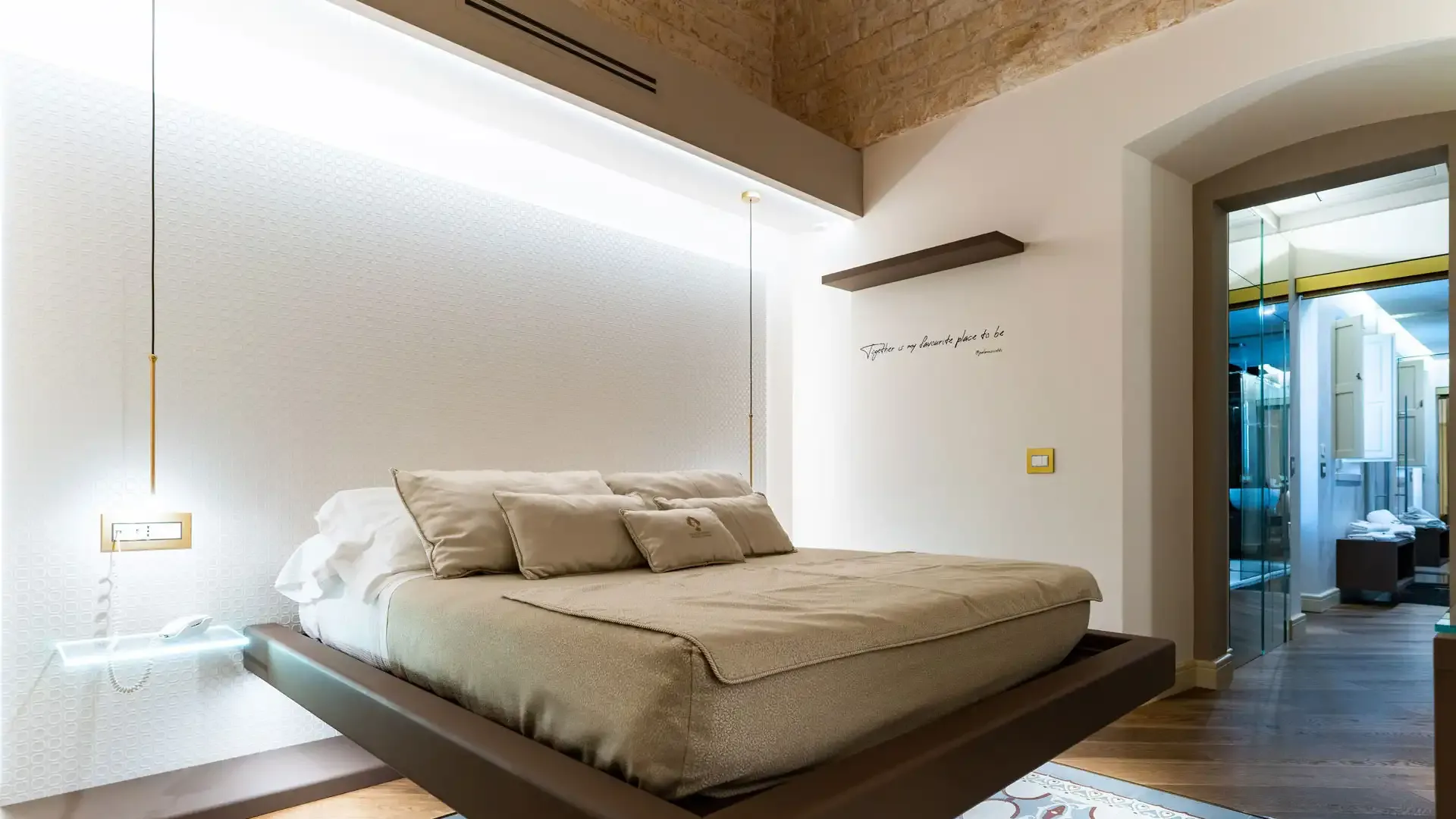 Modern bedroom with a floating bed and adjoining bathroom.