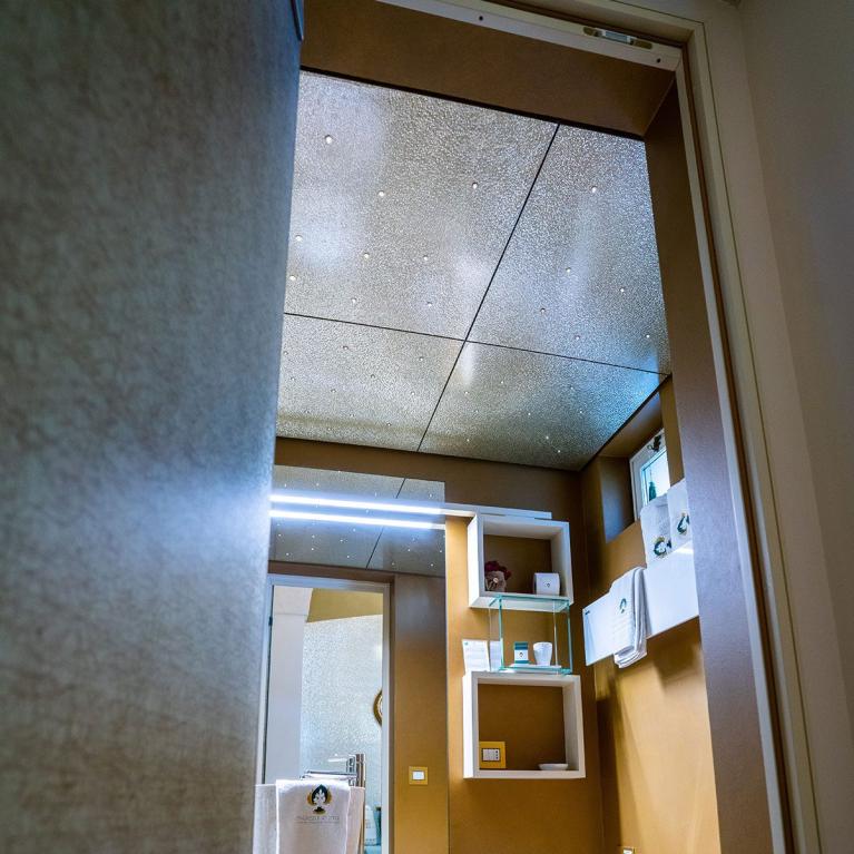 Modern bathroom with bidet, toilet, and wall shelves.