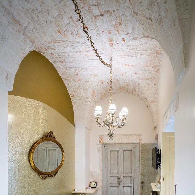 Elegant living room with vaulted stone ceiling and classic furnishings.